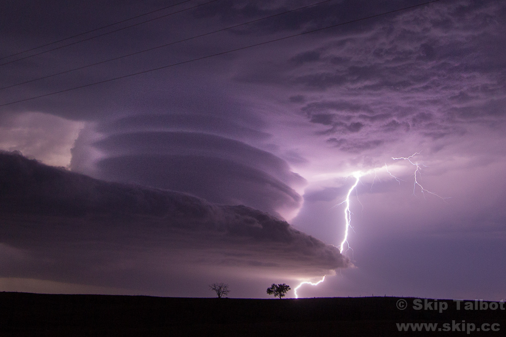 A supercell thunderstorm with a stacked plates appearance and a bolt of cloud to ground lightning