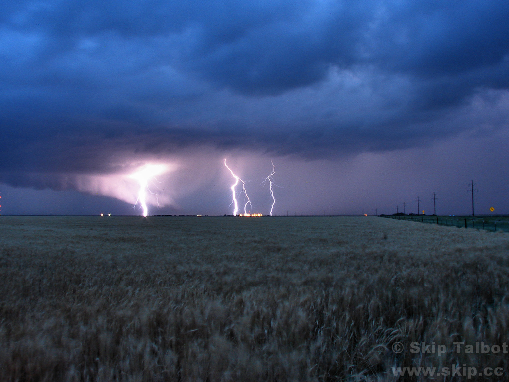 Several bolts of cloud to ground lightning illuminate a high-precipitation supercell